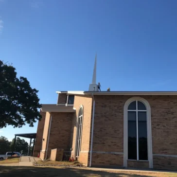 Roofing repairs on a church from storm damage in DFW
